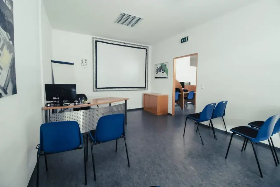 Schulungsraum der Fahrschule Gabriel mit Leinwand und Sitzplätzen